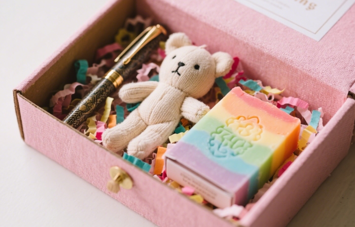 Open subscription box (FabFitFun, Book of the Month) revealing curated items