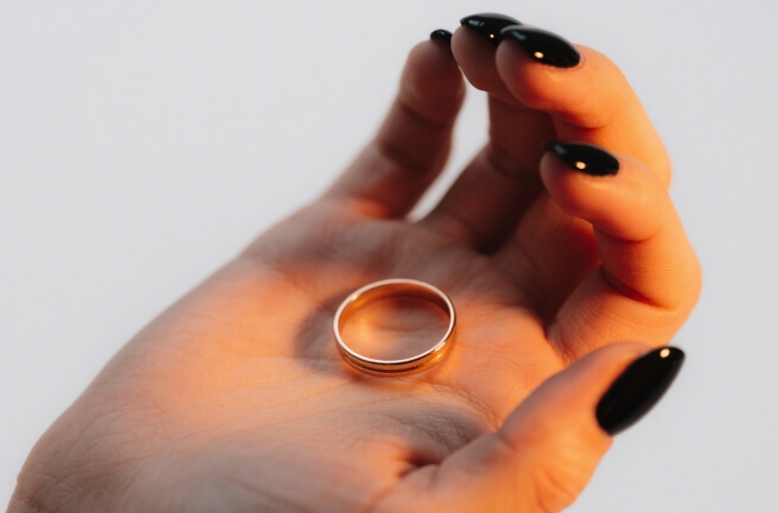 Slim rose gold fitness ring worn while hand-holding